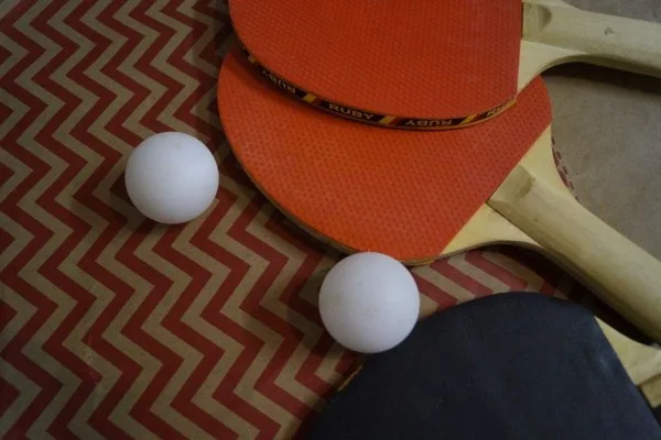 table tennis paddle and ball